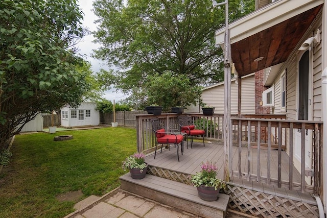 48 Rosemont St Unit 48, Haverhill, MA 01830 - wooden terrace featuring an outdoor fire pit, a fenced backyard, and an outdoor structure