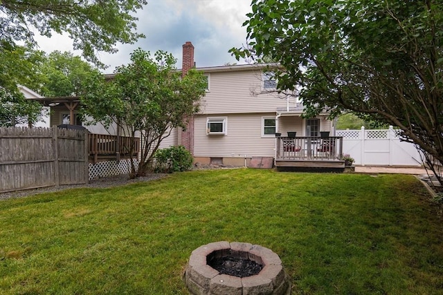 48 Rosemont St Unit 48, Haverhill, MA 01830 - back of house with a deck, a chimney, and a fire pit