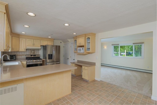48 Rosemont St Unit 48, Haverhill, MA 01830 - kitchen with stainless steel appliances, a baseboard radiator, light brown cabinets, a peninsula, and recessed lighting