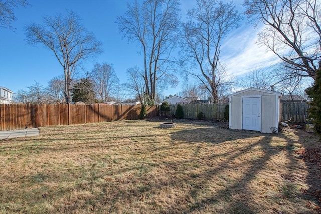 view of yard featuring a storage unit and an outdoor fire pit