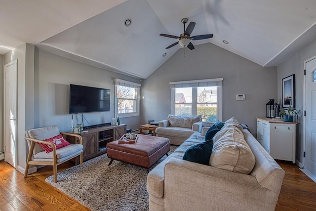 living room with ceiling fan, a healthy amount of sunlight, lofted ceiling, and hardwood / wood-style flooring