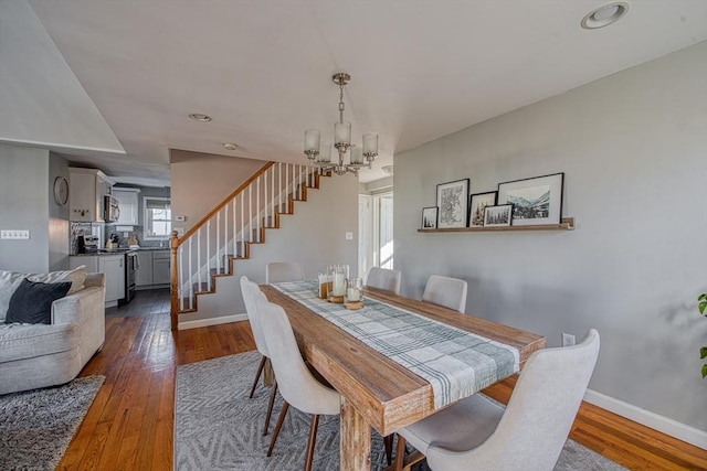 dining space featuring a chandelier and dark hardwood / wood-style floors