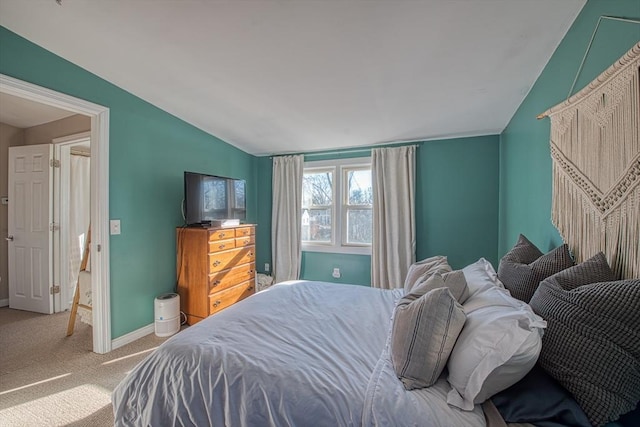 bedroom featuring carpet floors and vaulted ceiling