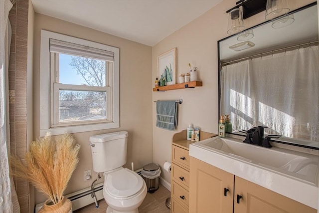 bathroom featuring tile patterned flooring, vanity, toilet, and baseboard heating