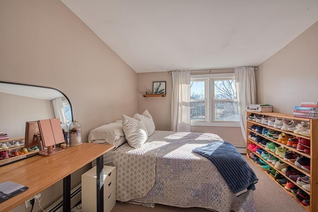 bedroom featuring lofted ceiling and a baseboard radiator