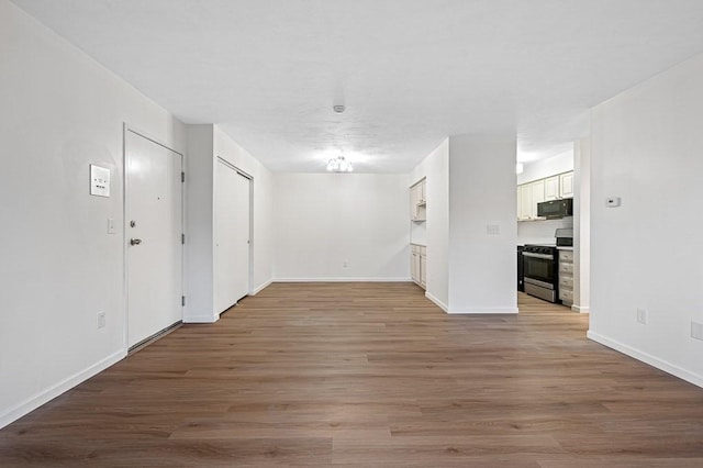 spare room featuring light hardwood / wood-style flooring