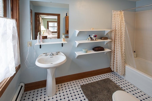 bathroom with shower / bath combo, a baseboard radiator, and toilet