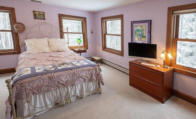 carpeted bedroom with a baseboard heating unit