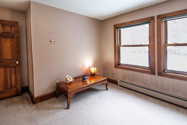 interior space with plenty of natural light, light carpet, and a baseboard radiator