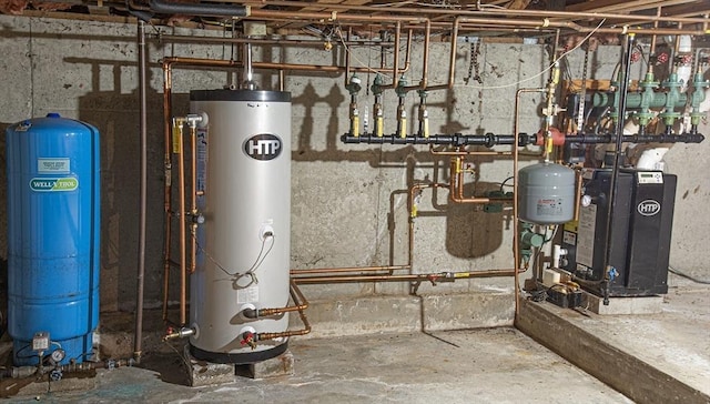 utility room featuring gas water heater and water heater