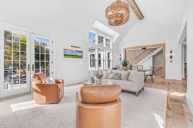 sunroom / solarium with lofted ceiling with beams and french doors