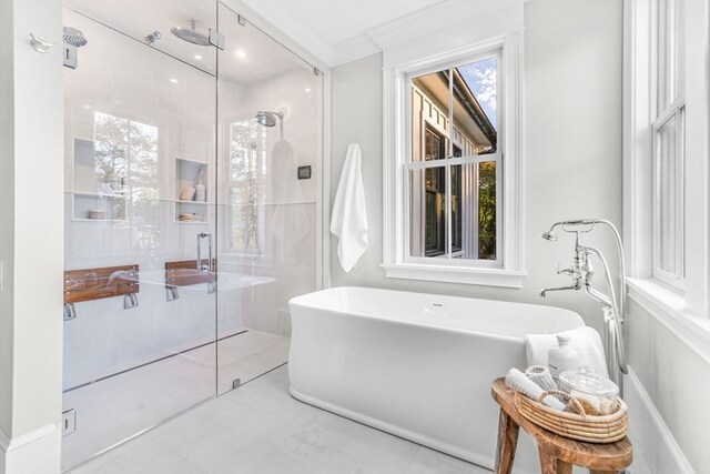 bathroom with ornamental molding and independent shower and bath