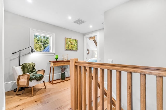 hallway with light hardwood / wood-style floors