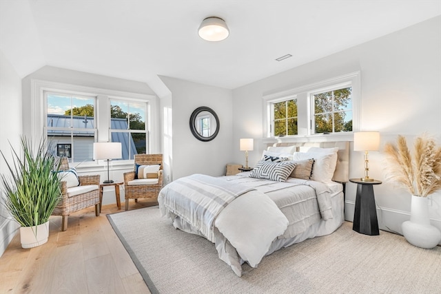 bedroom featuring hardwood / wood-style floors and multiple windows