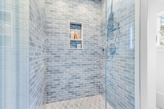 bathroom with a tile shower