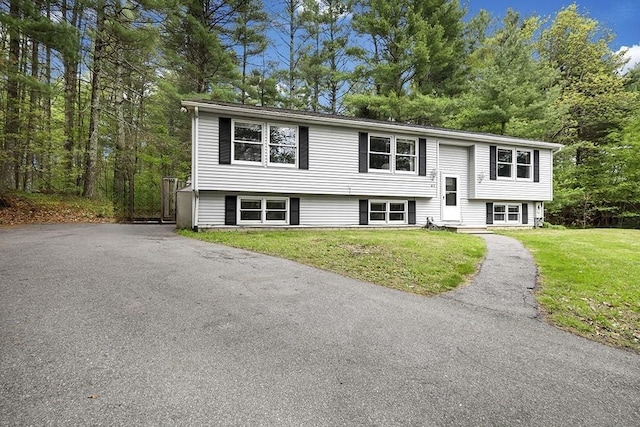 raised ranch featuring a front lawn