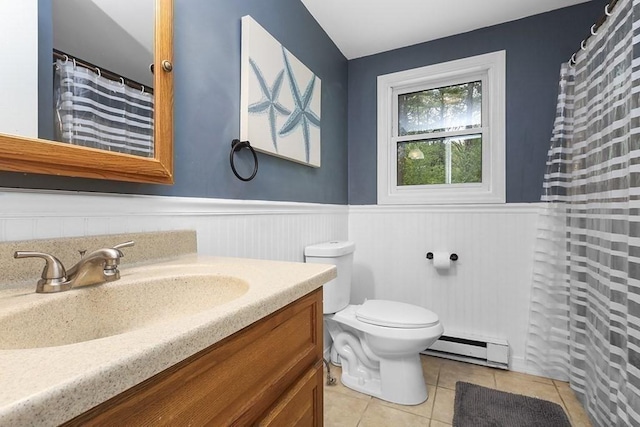 bathroom featuring a baseboard radiator, tile patterned flooring, a wainscoted wall, vanity, and toilet