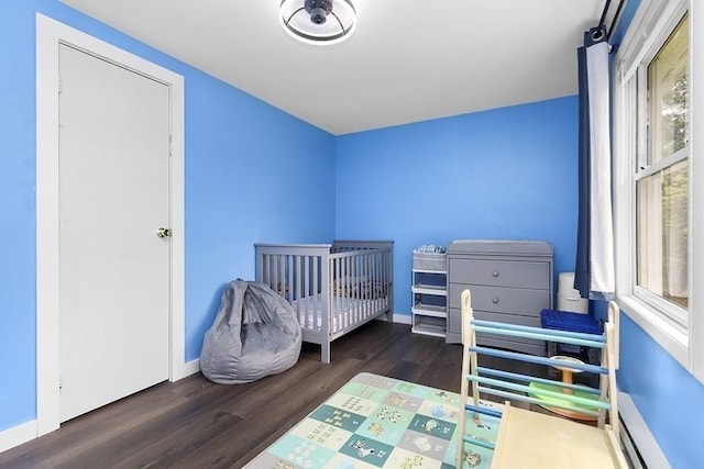 bedroom featuring wood finished floors and baseboards