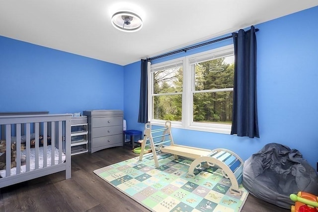 bedroom with dark wood-style flooring