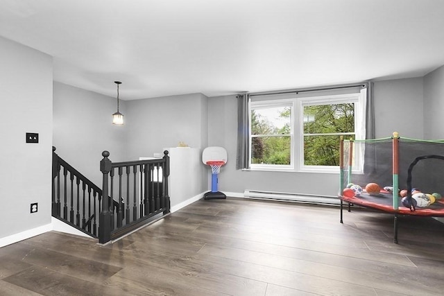 game room with wood finished floors, a baseboard radiator, and baseboards