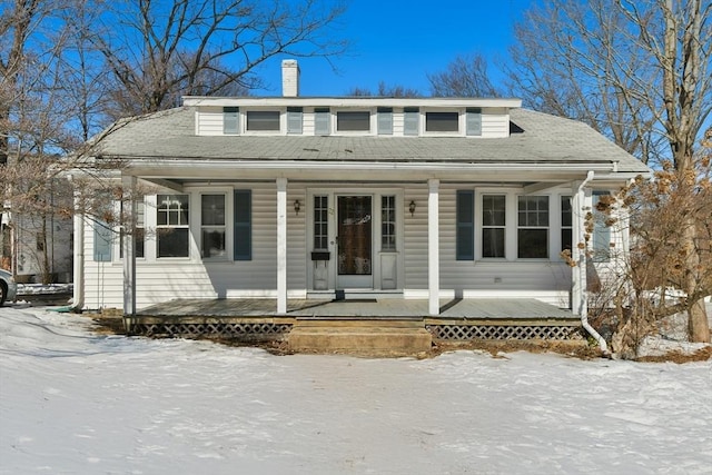 view of front of property with a porch and a chimney