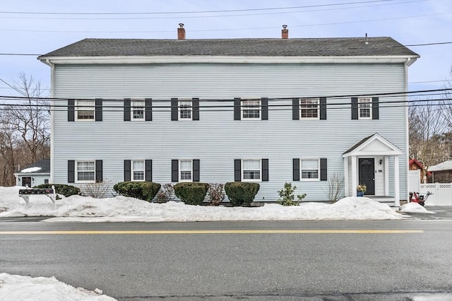 colonial inspired home with fence