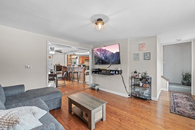 living area featuring light wood finished floors and baseboards