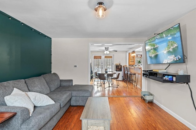 living room with baseboards and wood finished floors