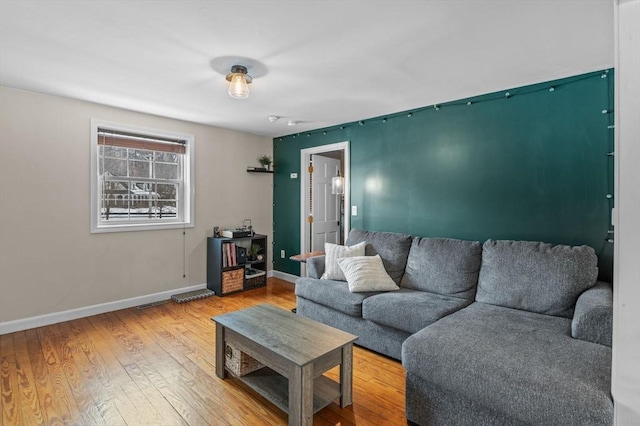 living area with hardwood / wood-style flooring and baseboards