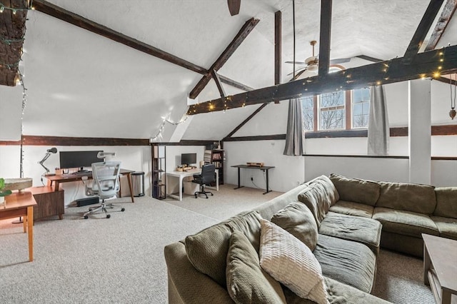 living area featuring lofted ceiling with beams, carpet, and a ceiling fan