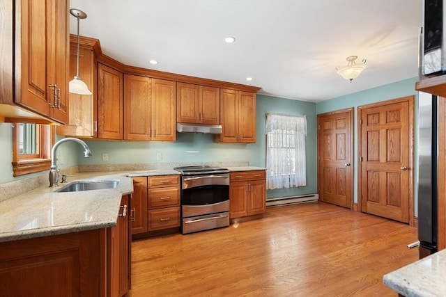 kitchen with pendant lighting, sink, stainless steel range with electric cooktop, a baseboard heating unit, and light hardwood / wood-style flooring