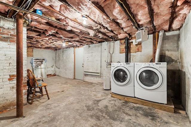 basement with separate washer and dryer and a wood stove