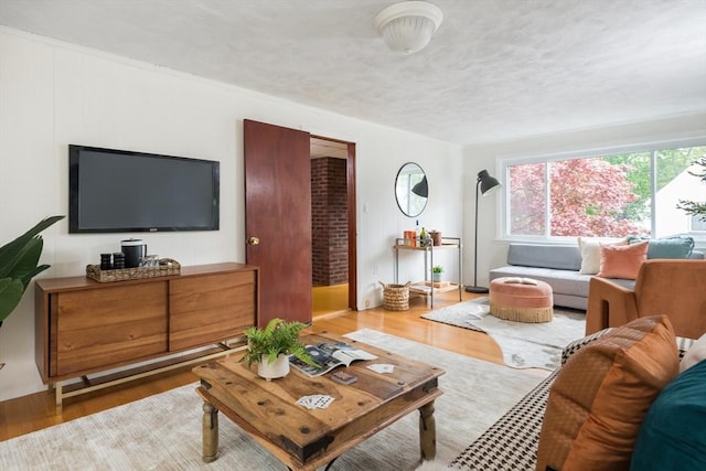 living area with plenty of natural light and wood finished floors