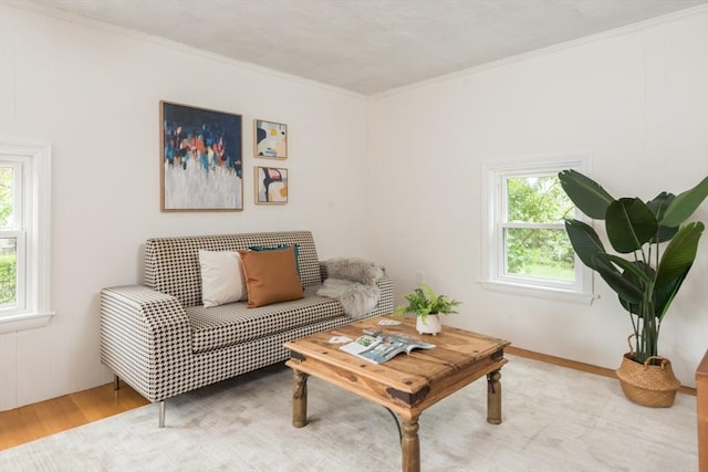 living room featuring light wood-style flooring and ornamental molding