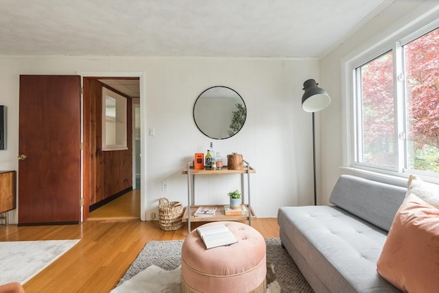 sitting room featuring wood finished floors and ornamental molding