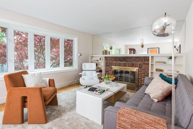 living room featuring wood finished floors, a fireplace, and baseboards