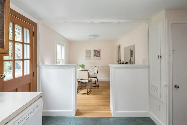 hallway featuring baseboards and light wood-style flooring