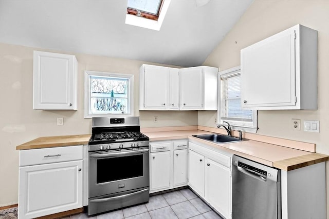 4 Morrison Way, Lakeville, MA 02347 - kitchen with stainless steel appliances, vaulted ceiling, white cabinetry, a skylight, and wooden counters