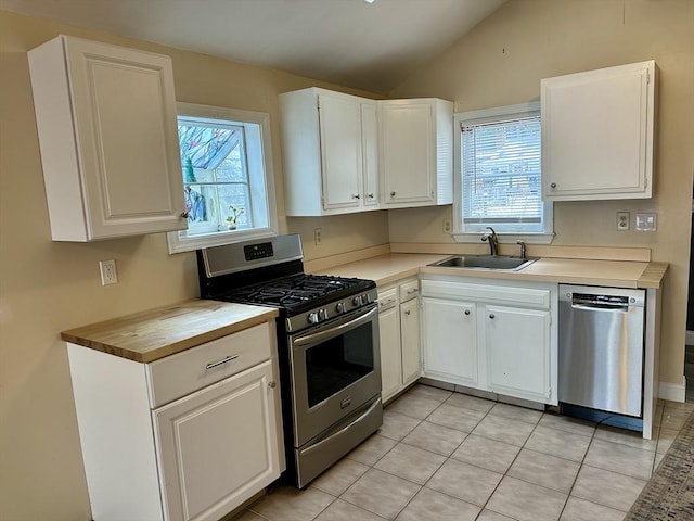 kitchen featuring sink, white cabinets, stainless steel appliances, and plenty of natural light