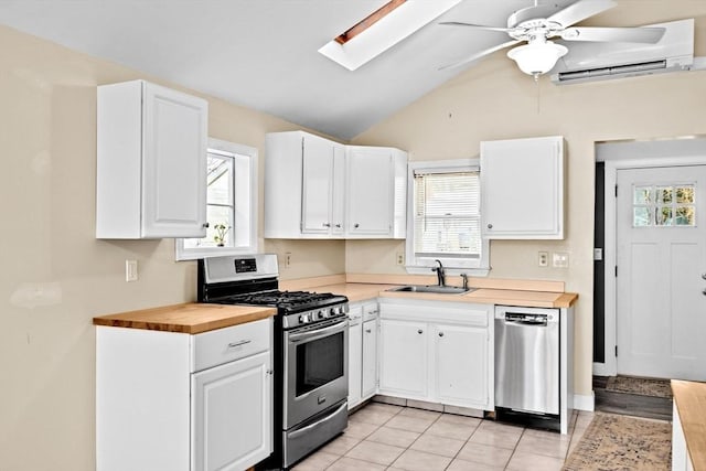 4 Morrison Way, Lakeville, MA 02347 - kitchen with appliances with stainless steel finishes, a wall mounted AC, butcher block countertops, a ceiling fan, and white cabinetry