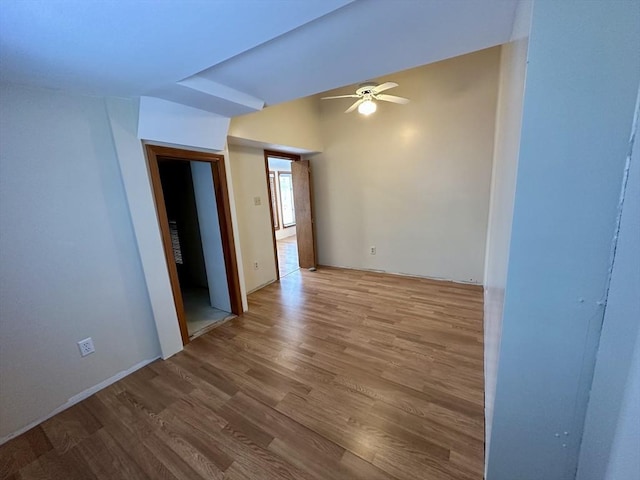 spare room with hardwood / wood-style floors and ceiling fan