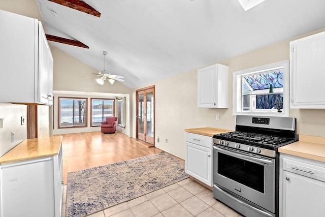 4 Morrison Way, Lakeville, MA 02347 - kitchen featuring stainless steel gas range, white cabinets, ceiling fan, light tile patterned floors, and high vaulted ceiling