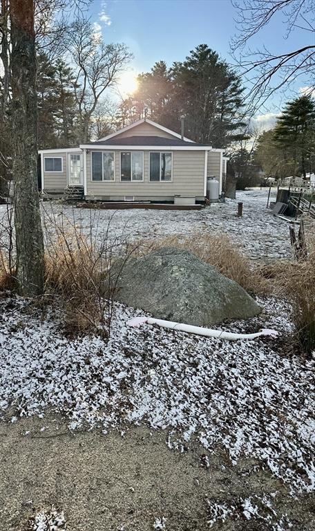 view of snow covered back of property