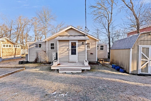 bungalow-style home with a storage unit