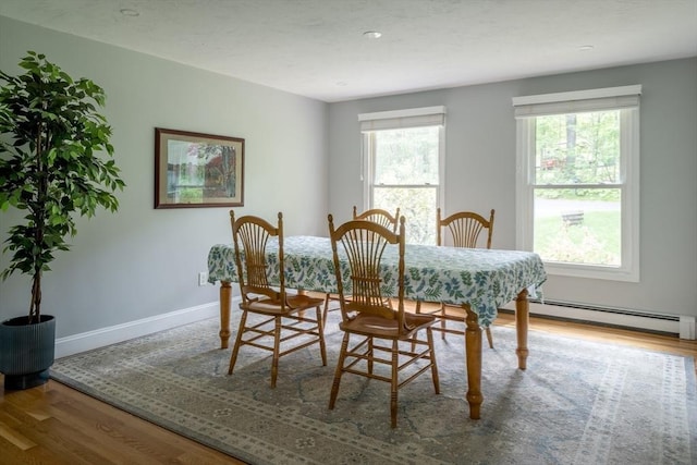 177 S St, Upton, MA 01568 - dining room with wood finished floors, plenty of natural light, and a baseboard heating unit