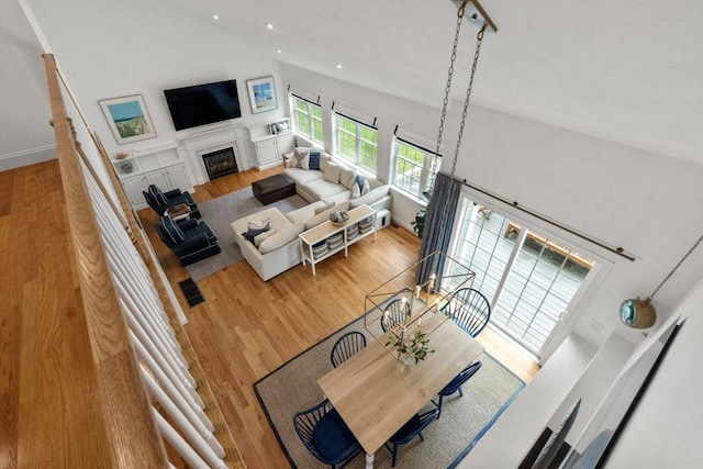 36 Village Way, Duxbury, MA 02332 - living area featuring wood finished floors, a fireplace, recessed lighting, a towering ceiling, and baseboards