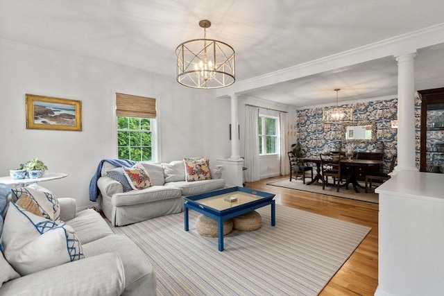 36 Village Way, Duxbury, MA 02332 - living room featuring decorative columns, a chandelier, plenty of natural light, and crown molding
