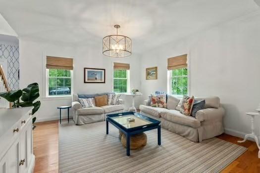 36 Village Way, Duxbury, MA 02332 - living area with light wood-style flooring, a chandelier, and baseboards