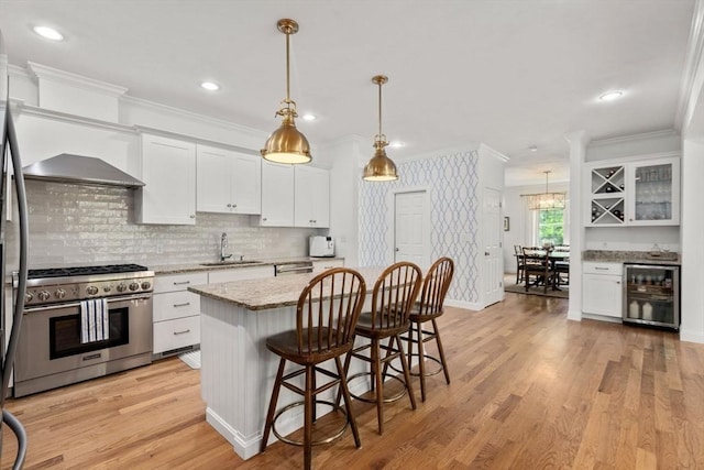 36 Village Way, Duxbury, MA 02332 - kitchen featuring stainless steel gas range, wine cooler, a sink, ornamental molding, and white cabinets
