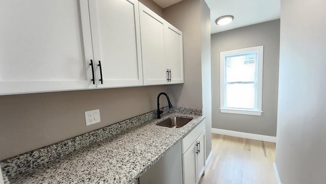 97-99 Blaisdell St Unit 3, Haverhill, MA 01832 - kitchen with white cabinetry, light stone counters, and light wood-style flooring